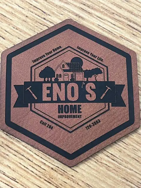 Hexagonal leather coaster laser-engraved with a custom home improvement business logo